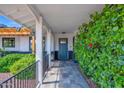 Covered front porch leads to front door with nice landscaping and new outdoor lighting at 8730 E Montecito Ave, Scottsdale, AZ 85251