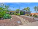 Desert landscaping and stone details highlight this home's curb appeal at 8730 E Montecito Ave, Scottsdale, AZ 85251