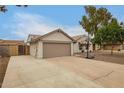 Long driveway leads to the garage, with a view of the front lawn and house at 908 W Mohawk Ln, Phoenix, AZ 85027