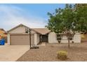 Single story home with a basketball hoop, well maintained yard, and a two car garage at 908 W Mohawk Ln, Phoenix, AZ 85027