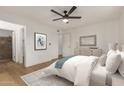 Bright main bedroom with light-colored walls, a white bedspread, and an ensuite bathroom at 908 W Mohawk Ln, Phoenix, AZ 85027
