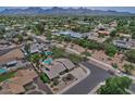 Expansive aerial view showcasing the neighborhood, backing up to mountains, with tree-lined streets at 9476 E Laurel Ln, Scottsdale, AZ 85260