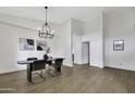 Airy dining room featuring wood floors, modern lighting, and neutral decor at 1441 W Sea Haze Dr, Gilbert, AZ 85233