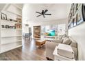 Bright living room featuring wood floors, ceiling fan, and large windows at 14801 N 25Th Dr # 2, Phoenix, AZ 85023