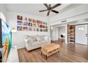 Spacious living room with wood flooring, ceiling fan, and stylish decor at 14801 N 25Th Dr # 2, Phoenix, AZ 85023