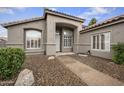 Inviting stucco home with a covered entrance, desert landscaping, and plenty of natural light at 15064 N 54Th Way, Scottsdale, AZ 85254