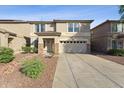 Inviting two-story home with a two-car garage, stone accents, and a well-maintained front yard at 1821 E Patrick Ln, Phoenix, AZ 85024