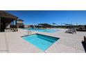 Inviting community pool and spa with lounge chairs under a clear blue sky at 19320 N Diego Way, Maricopa, AZ 85138
