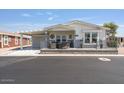 Inviting single-story home featuring a cozy front porch, perfect for enjoying the outdoors at 2206 S Ellsworth Rd # 160B, Mesa, AZ 85209