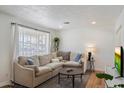 Cozy living area with a large sectional sofa and stylish decor at 2223 E Roma Ave, Phoenix, AZ 85016