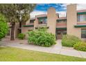 Attractive townhome complex featuring tiled roofs and lush green landscaping at 225 W 1St St # 107, Mesa, AZ 85201