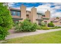 Charming multi-story townhome featuring a tiled roof and well-maintained front lawn at 225 W 1St St # 107, Mesa, AZ 85201