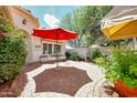 Charming courtyard with a fountain, comfortable seating, and lush landscaping at 23309 N Las Positas Ct, Sun City West, AZ 85375