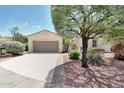 Charming single-story home featuring a tile roof, desert landscaping, and a spacious two-car garage at 23309 N Las Positas Ct, Sun City West, AZ 85375