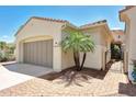 Exterior view of home featuring a two-car garage, desert landscaping, and covered entry way at 23309 N Las Positas Ct, Sun City West, AZ 85375