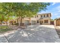 Spacious two-story home with a three-car garage and desert landscaping, perfect for Gathering living at 29475 N Candlewood Dr, San Tan Valley, AZ 85143