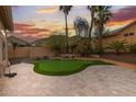 Private backyard features a putting green, desert landscaping, and a block fence at 3102 E Desert Broom Way, Phoenix, AZ 85048