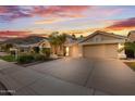 A well-maintained home featuring a spacious driveway and a three-car garage at 3102 E Desert Broom Way, Phoenix, AZ 85048