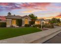 Landscaped front yard features a well-manicured lawn and mature shade trees at 3102 E Desert Broom Way, Phoenix, AZ 85048