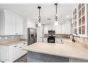 Bright kitchen features stainless steel appliances, white cabinetry, stylish countertops and decorative backsplash at 3444 E Flamingo Ct, Gilbert, AZ 85297