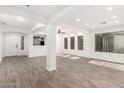 Open living space with wood-look flooring, open doorway and natural light at 3444 E Flamingo Ct, Gilbert, AZ 85297