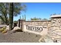 Elegant stone entrance sign for Treviso West, a Toll Brothers community, under a clear blue sky at 36674 N Vasari Dr, Scottsdale, AZ 85262