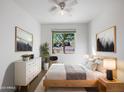 Comfortable bedroom with a large window, stylish furnishings, and ample natural light at 42099 W Balsa Dr, Maricopa, AZ 85138