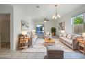 Bright living room featuring neutral decor, plush seating, area rug, and a view to the backyard at 42099 W Balsa Dr, Maricopa, AZ 85138