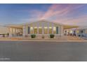 Inviting single-story home featuring covered patios, manicured landscaping, and a welcoming facade at dusk at 5735 E Mcdowell Rd # 388, Mesa, AZ 85215