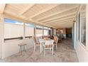 Enclosed patio with tile flooring, neutral paint, and table with chairs for outdoor relaxation at 5735 E Mcdowell Rd # 388, Mesa, AZ 85215