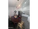 Functional kitchen with white cabinets, tiled flooring, and a dining table at 6010 W Coolidge St, Phoenix, AZ 85033