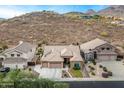 Aerial view of home with desert landscaping, desert mountain views and close proximity to neighbors at 6326 W Misty Willow Ln, Glendale, AZ 85310