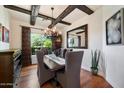 Charming dining room with hardwood floors, a chandelier, and exposed wood beams for a rustic touch at 7002 E Aster Dr, Scottsdale, AZ 85254