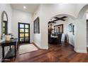 Inviting foyer featuring hardwood floors, decorative art, and access to the formal dining room at 7002 E Aster Dr, Scottsdale, AZ 85254