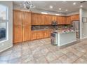 Modern kitchen with a large island, custom cabinetry, and an ice maker at 7252 E Nance St, Mesa, AZ 85207