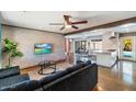 Open-concept living room featuring brick accent wall, modern furnishings, and seamless flow to dining area at 7326 E Portland St, Scottsdale, AZ 85257