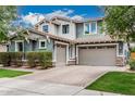 Charming home with a three-car garage, stone accents, and a well-maintained yard at 7528 E Peralta Ave, Mesa, AZ 85212