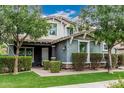 Attractive home with mature trees, well-kept lawn, and welcoming front entrance at 7528 E Peralta Ave, Mesa, AZ 85212