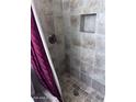Shower with brown tiling, silver hardware, and shower niche at 8055 E Thomas Rd # H103, Scottsdale, AZ 85251