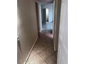 Hallway featuring neutral walls, tile floors and a door leading to a bathroom at 8055 E Thomas Rd # H103, Scottsdale, AZ 85251