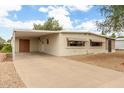 Exterior view showcasing the home's covered parking and neutral color palette at 8302 E Dutchman Dr, Mesa, AZ 85208