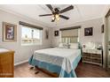 Serene bedroom with natural light, wood-look floors, and calm decor for a relaxing retreat at 8330 E Pueblo Ave, Mesa, AZ 85208