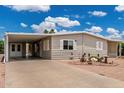 Home featuring low-maintenance gravel landscaping and covered carport for convenient parking at 8330 E Pueblo Ave, Mesa, AZ 85208