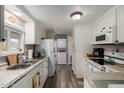Bright kitchen featuring white cabinetry, modern appliances, and durable countertops for easy cooking at 8330 E Pueblo Ave, Mesa, AZ 85208