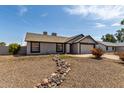 View of single-level home with low maintenance landscaping at 8703 W Golden Ln, Peoria, AZ 85345