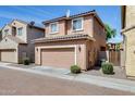 Two-story home featuring an attached garage, a desert-landscaped yard, and a brick-paved street at 9 N 87Th N Ln, Tolleson, AZ 85353