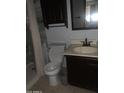 Standard bathroom with shower/tub combo and dark cabinets, providing functionality at 108 E Jasmine St, Mesa, AZ 85201
