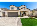 Two-story home with a spacious driveway and a charming covered porch at 1297 W Chillingham W Rd, San Tan Valley, AZ 85143