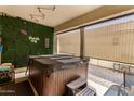 Cozy outdoor patio featuring a hot tub and decorative greenery at 1297 W Chillingham W Rd, San Tan Valley, AZ 85143