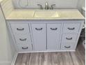 Bathroom vanity with granite countertop, white cabinets, and bronze hardware at 13013 N 18Th St, Phoenix, AZ 85022